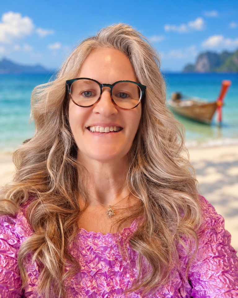Stacey Martin, owner and sewing machine educator at Sew & Saw Studio in Dandridge, Tennessee, smiling with a Thailand-inspired beach and long-tail boat background.